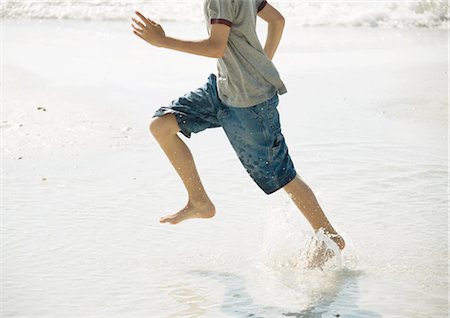 summer beach break - Boy running in surf on beach Stock Photo - Premium Royalty-Free, Code: 695-03373398