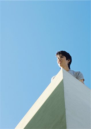simsearch:695-03373539,k - Young man, low angle view with sky in background Stock Photo - Premium Royalty-Free, Code: 695-03373540