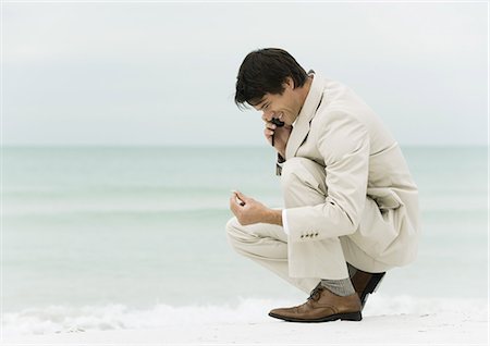 simsearch:633-01574593,k - Businessman using cell phone on the beach Stock Photo - Premium Royalty-Free, Code: 695-03373572