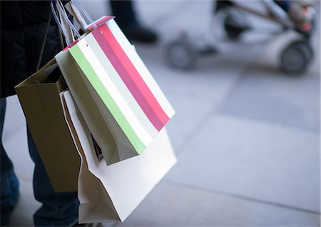 Person carrying shopping bags Stock Photo - Premium Royalty-Free, Code: 695-03373691