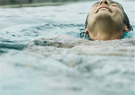 space with a person floating - Man smiling with head back in swimming pool Stock Photo - Premium Royalty-Free, Code: 695-03373733