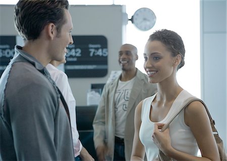 simsearch:695-03388701,k - Group of people standing, smiling, in boarding area of airport Stock Photo - Premium Royalty-Free, Code: 695-03373798