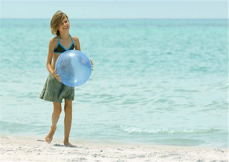 Girl holding beach ball on beach Stock Photo - Premium Royalty-Free, Code: 695-03373992
