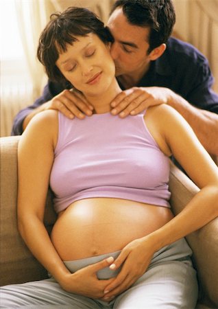 simsearch:632-01140106,k - Man massaging pregnant woman's shoulders, kissing her neck Stock Photo - Premium Royalty-Free, Code: 695-03384026