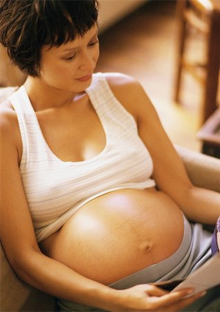 short haired women pregnant - Pregnant woman reading in armchair, high angle view Stock Photo - Premium Royalty-Free, Code: 695-03384021