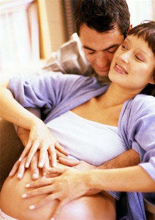 simsearch:632-01140106,k - Man touching pregnant woman's stomach from behind Stock Photo - Premium Royalty-Free, Code: 695-03384032