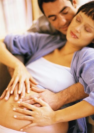 simsearch:632-01140106,k - Man touching pregnant woman's stomach from behind Stock Photo - Premium Royalty-Free, Code: 695-03384033