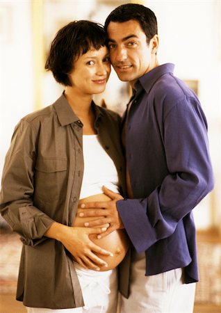 simsearch:632-01140106,k - Man touching pregnant woman's stomach, portrait Stock Photo - Premium Royalty-Free, Code: 695-03384042