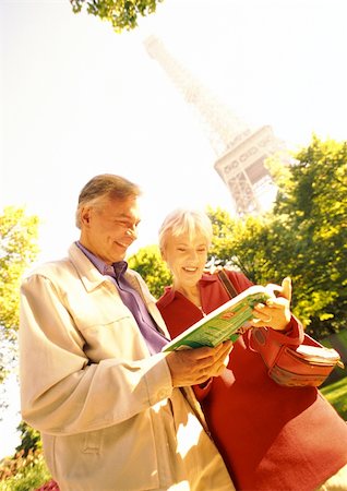 eiffel tower picture color - France, Paris, mature woman and man examining a book, Eiffel Tower in background Stock Photo - Premium Royalty-Free, Code: 695-03384109