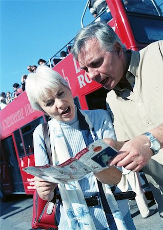 senior couple looking at map - Mature woman and man examining a brochure Stock Photo - Premium Royalty-Free, Code: 695-03384111