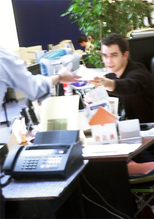 In office, man handing document to second person, blurred Stock Photo - Premium Royalty-Free, Code: 695-03384152