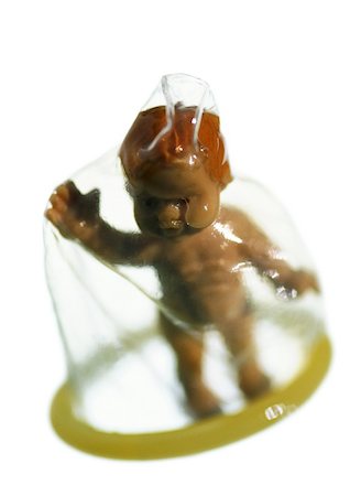 simsearch:695-05770657,k - Plastic baby doll standing under condom, close-up Foto de stock - Sin royalties Premium, Código: 695-03384286