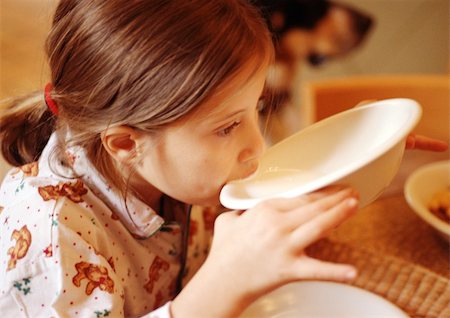 Child drinking from bowl, side view Stock Photo - Premium Royalty-Free, Code: 695-03384583