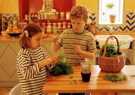 Children in kitchen handling herbs Stock Photo - Premium Royalty-Free, Code: 695-03384593