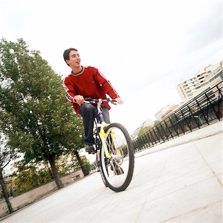 Young man on bike Stock Photo - Premium Royalty-Free, Code: 695-03384738