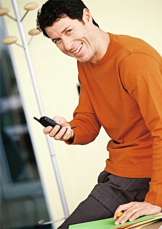 simsearch:632-02745019,k - Man holding cell phone, portrait Stock Photo - Premium Royalty-Free, Code: 695-03384814