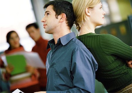 Businessman and woman back to back Stock Photo - Premium Royalty-Free, Code: 695-03384825