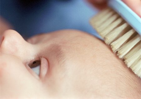 simsearch:695-03384923,k - Baby having hair brushed, close-up of head and brush, partial view Stock Photo - Premium Royalty-Free, Code: 695-03384936