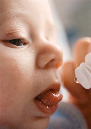 simsearch:695-05778625,k - Baby's face and end of vitamin dropper, close-up Stock Photo - Premium Royalty-Free, Code: 695-03384948