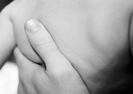 simsearch:695-03384923,k - Adult's hand on baby's back, close-up, b&w Stock Photo - Premium Royalty-Free, Code: 695-03384941
