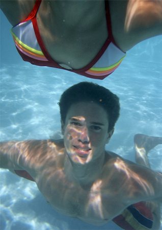 swimming pool candid - Close-up of teenagers swimming in pool. Stock Photo - Premium Royalty-Free, Code: 695-03385135