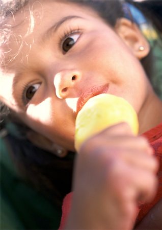 Girl eating ice cream, close-up Stock Photo - Premium Royalty-Free, Code: 695-03385167