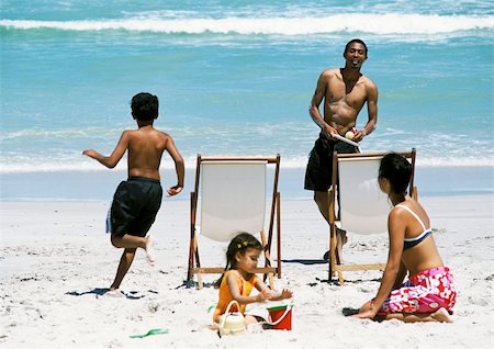 family relaxing with kids in the sun - Family on beach Stock Photo - Premium Royalty-Free, Code: 695-03385194