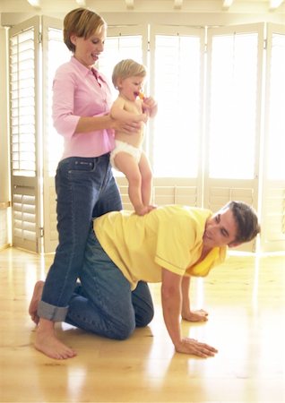 simsearch:695-03384752,k - Man on all fours, woman holding baby on his back Foto de stock - Royalty Free Premium, Número: 695-03385305