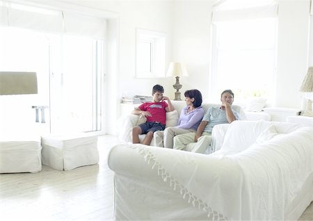 parent comforting teen - Couple and teenage boy sitting on sofa Stock Photo - Premium Royalty-Free, Code: 695-03385326