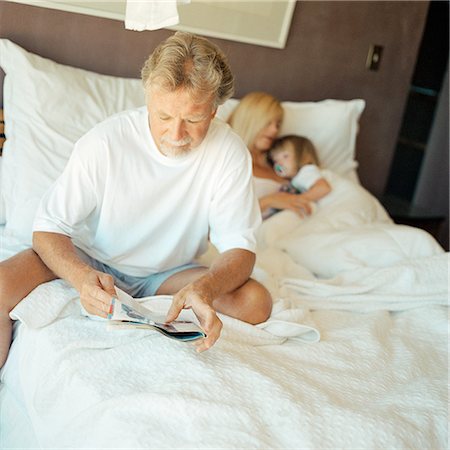 Couple and child on bed Stock Photo - Premium Royalty-Free, Code: 695-03385350