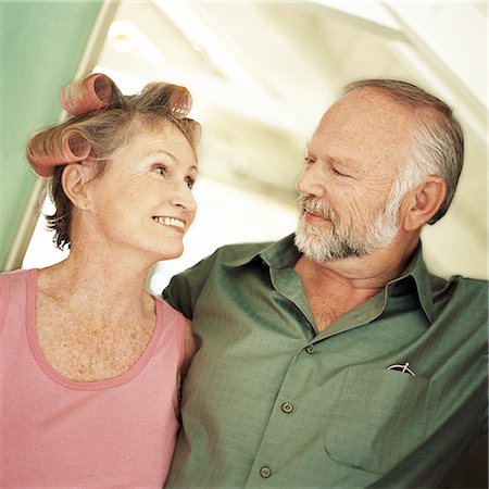 Mature couple looking at each other, woman with rollers in hair, portrait Stock Photo - Premium Royalty-Free, Code: 695-03385426