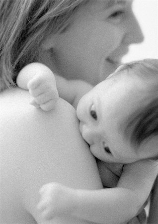 Mother holding infant next to bare shoulder, b&w Stock Photo - Premium Royalty-Free, Code: 695-03385494