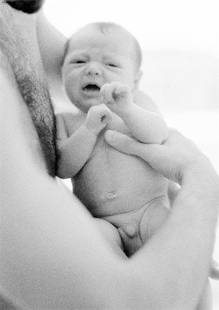 father and child cry - Father holding crying infant in arms, b&w Stock Photo - Premium Royalty-Free, Code: 695-03385504