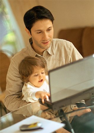 Father and baby using laptop. Stock Photo - Premium Royalty-Free, Code: 695-03385590