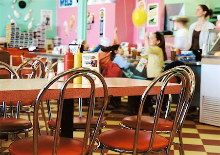 Children having party in restaurant, empty tables in foreground. Stock Photo - Premium Royalty-Free, Code: 695-03385614