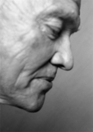 Senior man looking down, side view, close-up, b&w Stock Photo - Premium Royalty-Free, Code: 695-03385679