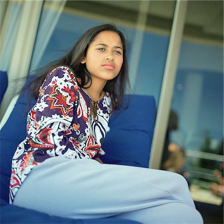 Girl sitting with legs crossed, portrait Stock Photo - Premium Royalty-Free, Code: 695-03385726