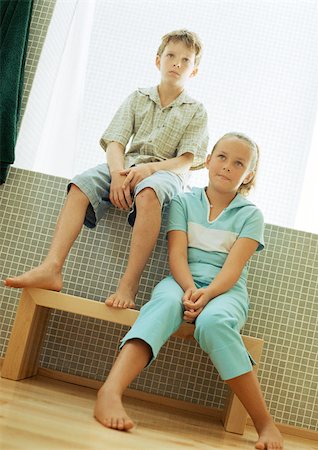 females sitting on the toilet - Boy sitting on window ledge and girl sitting on bench below Stock Photo - Premium Royalty-Free, Code: 695-03385732