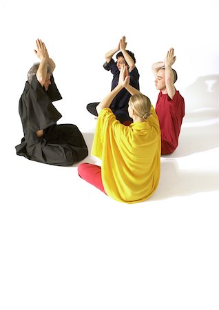 simsearch:695-03385803,k - Group of people sitting on floor indian style, meditating with hands togther over heads Stock Photo - Premium Royalty-Free, Code: 695-03385769