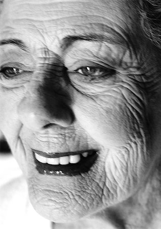 person growing old - Senior woman smiling, side view, close-up, b&w. Stock Photo - Premium Royalty-Free, Code: 695-03385880