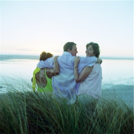 simsearch:700-01639961,k - Mature friends with arms around each other, standing on beach, rear view Stock Photo - Premium Royalty-Free, Code: 695-03386188