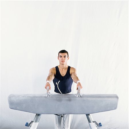 simsearch:632-01145012,k - Gymnast mounting pommel horse, looking at camera Stock Photo - Premium Royalty-Free, Code: 695-03386231