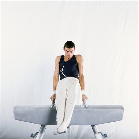 simsearch:632-01145012,k - Young male gymnast performing routine on pommel horse Stock Photo - Premium Royalty-Free, Code: 695-03386233