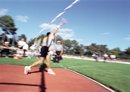 Male athlete throwing javelin, blurred motion Stock Photo - Premium Royalty-Free, Code: 695-03386277