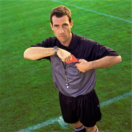 fault - Referee pulling out red card, looking into camera. Stock Photo - Premium Royalty-Free, Code: 695-03386383