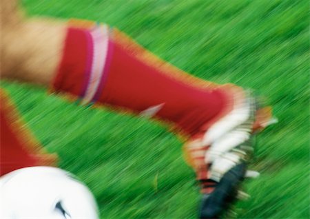 Fußballspieler mit Ball, niedrig, Abschnitt, Nahaufnahme, verschwommen. Stockbilder - Premium RF Lizenzfrei, Bildnummer: 695-03386394