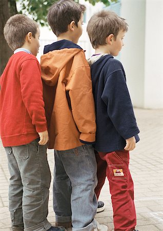 pictures of kids and friends playing at school - Three children in single file, side view, full length, close-up Stock Photo - Premium Royalty-Free, Code: 695-03386768