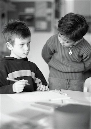 Two children, one holding pencil, b&w Stock Photo - Premium Royalty-Free, Code: 695-03386761