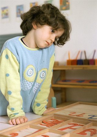 simsearch:695-05776481,k - Child looking at plastic letters Stock Photo - Premium Royalty-Free, Code: 695-03386776