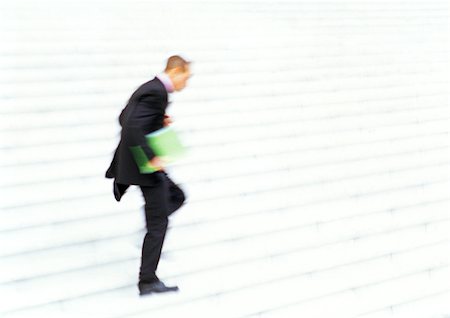 run stair - Businessman running down steps, side view, blurred motion Stock Photo - Premium Royalty-Free, Code: 695-03386779
